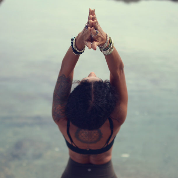 Woman doing a yoga backbend on the beach