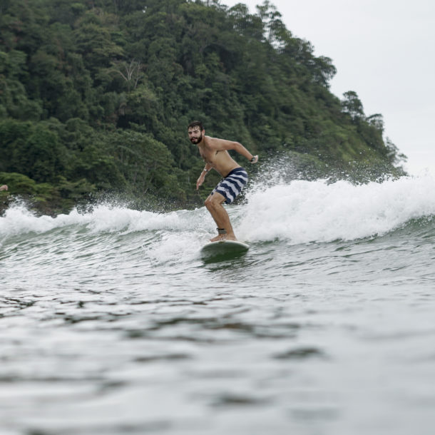 Man surfing with mountain in the background