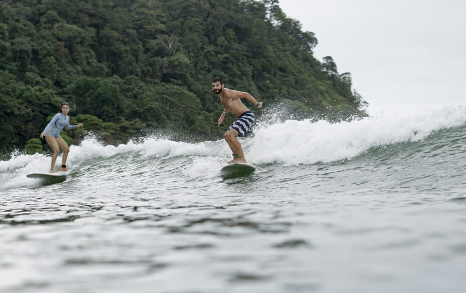 Man surfing with mountain in the background